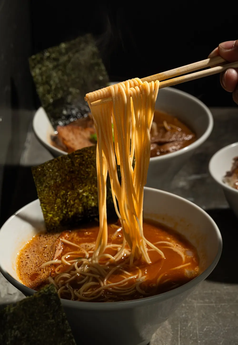 Noodles lifted from the bowl
